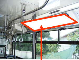 バスの車両内を大きくうつしており、窓よりも上の有料広告を掲載する箇所を赤い印で囲っている写真